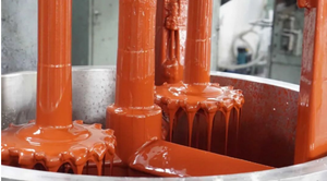Close-up of orange epoxy adhesive being poured, showing its thick gel-like texture